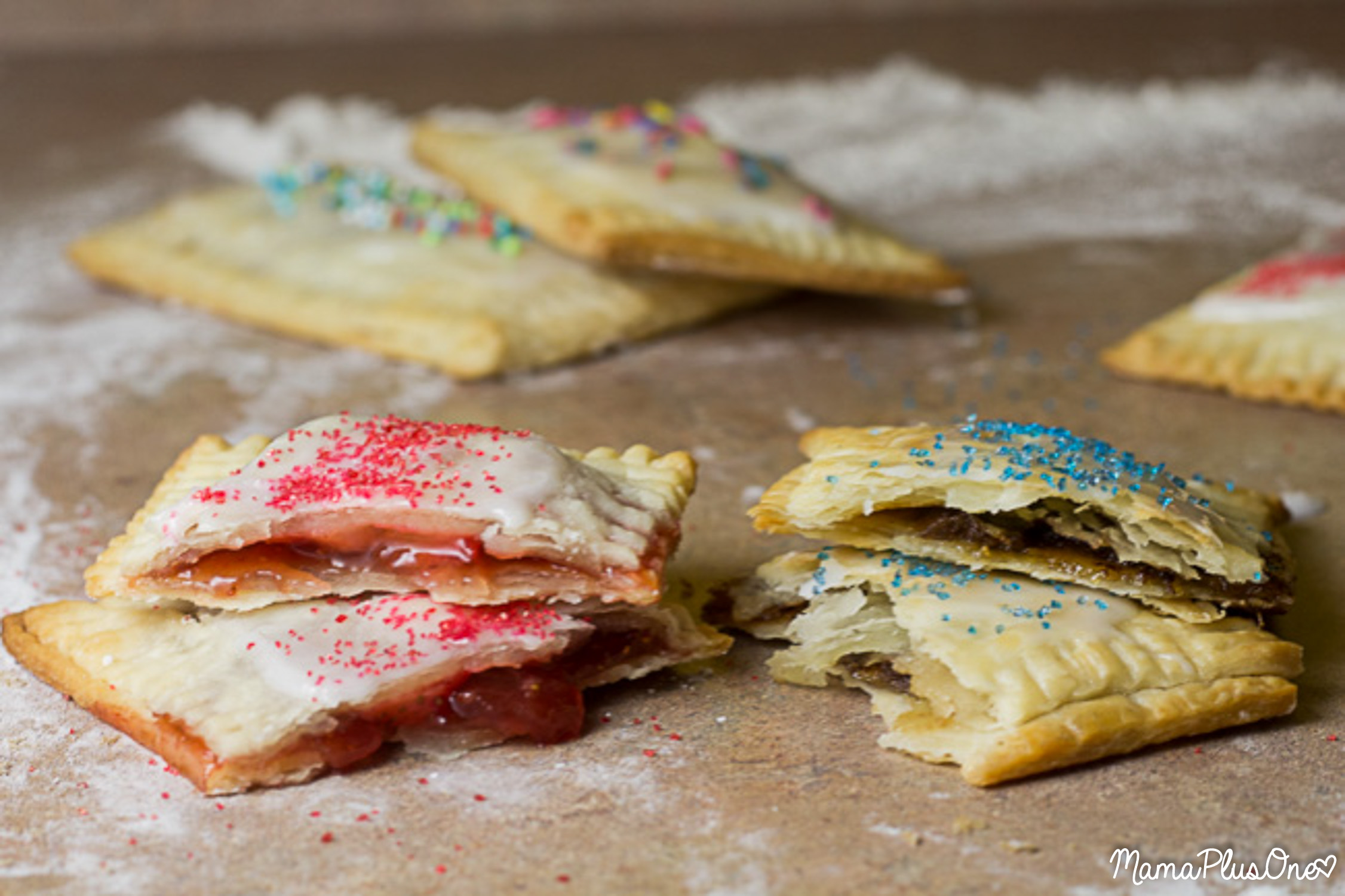 I love a good toaster pastry, especially Pop Tarts, but if you make these, you are never going to buy storebought again… flaky crust, hearty filling, deliciously sweet, tender flavor, and sprinkles in any color of the rainbow! Plus, they’re super easy to make with a semi-homemade filling! Get these yummy toaster pastries on your table in a matter of minutes (and get your kids enjoying some real fruit inside!) A homemade toaster pastry is the perfect breakfast treat for your on-the-go family! | homemade pop tarts | easy breakfast idea | breakfast pastry recipe |