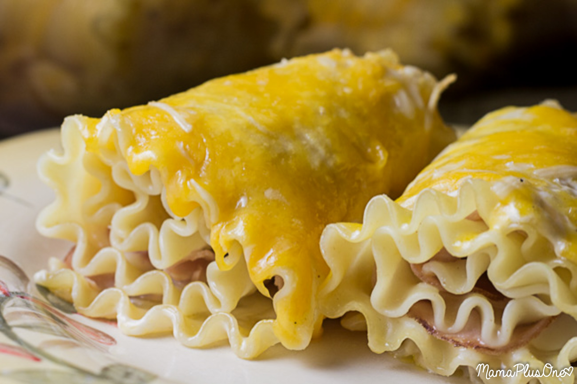 Ham and Cheese Lasagna Roll Ups are the perfect choice for a weeknight meal. They're easy to make and taste delicious, pairing your favorite ham and cheese sandwich with a delicious lasagna twist. | weeknight meal | lasagna roll up | ham and cheese | easy dinner idea |